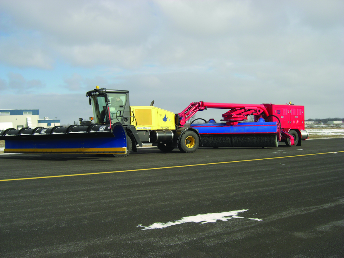 Tow Behind Broom with a Wausau Runway Snow Plow From Wausau Equipment