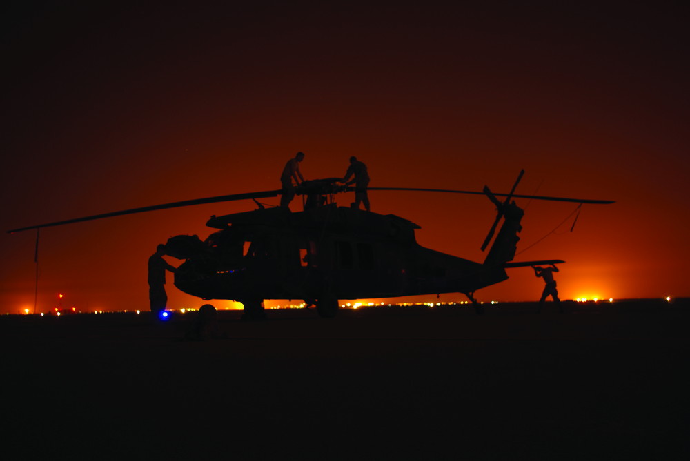 Minnesota National Guard technicians at night accomplishing a PMD check on a Black Hawk in Basra, Iraq. Photo courtesy of Keith Shelstad.
