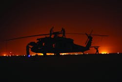 Minnesota National Guard technicians at night accomplishing a PMD check on a Black Hawk in Basra, Iraq. Photo courtesy of Keith Shelstad.