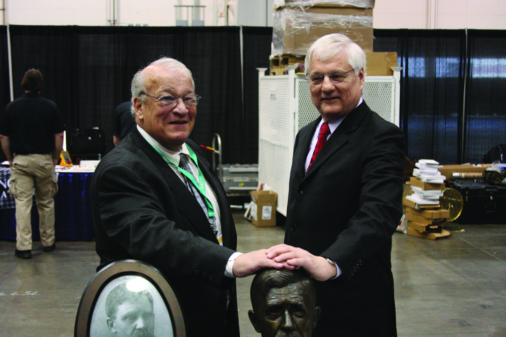 John Goglia and Jim Ballough with Charles Taylor bust at AMTSociety Maintenance Skills Competition.