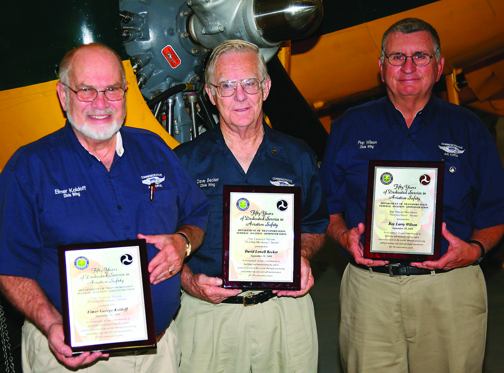 Dave Becker , of Fayetteville, GA, and Elmer Koldoff, of Peachtree City, GA, receive Charles E. Taylor Master Mechanic Awards. Also shown is Ray 'Pop' Wilson who received the Master Pilot Award.