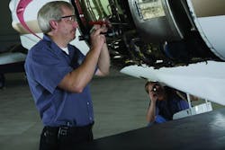 Technicians inspecting a corporate jet at Fargo Jet Center.