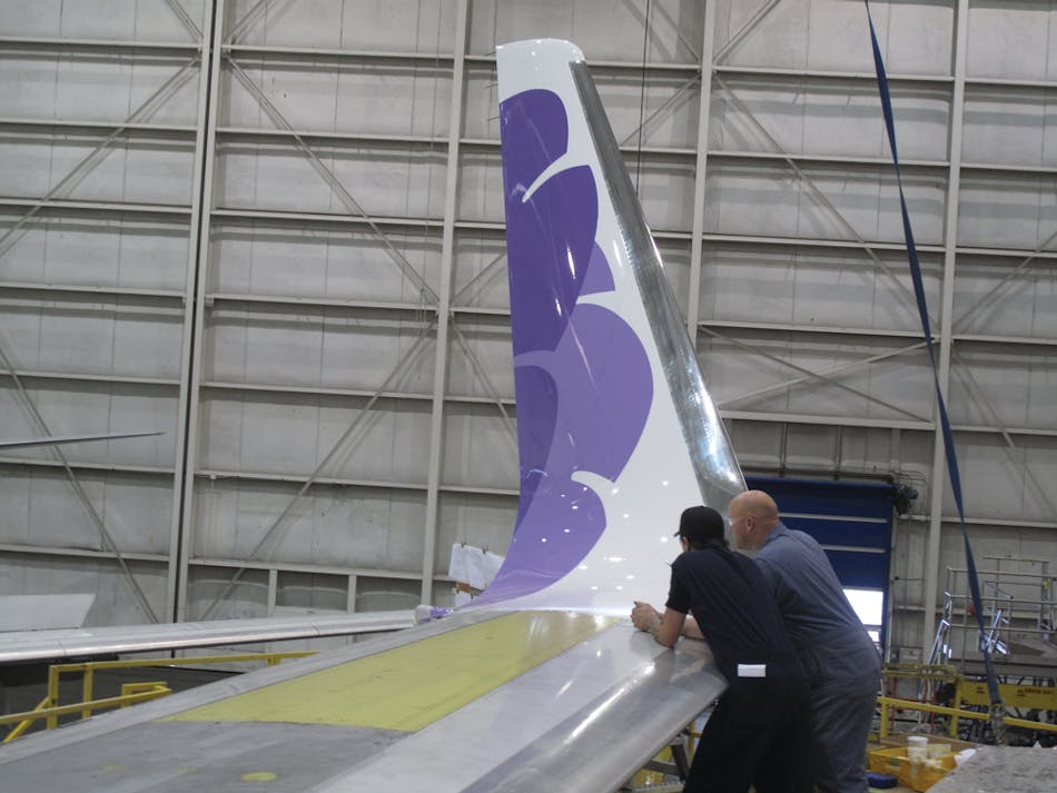 ATS technicians admiring the completion of an APB blended winglet installation on a Hawaiian Airlines aircraft.