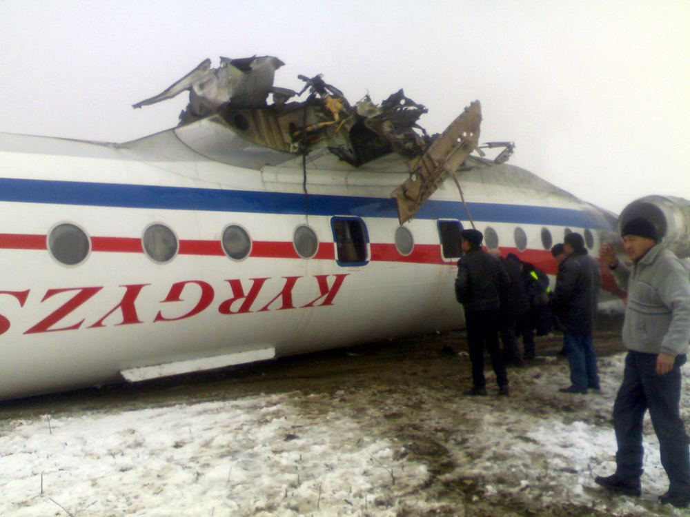 Emergency rescue gather around an overturned Soviet-built Tupolev Tu-134 passenger jet after it crash-landed in deep fog in Osh, Kyrgyzstan, Wednesday, Dec. 28, 2011.