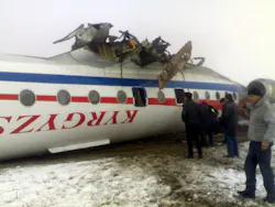 Emergency rescue gather around an overturned Soviet-built Tupolev Tu-134 passenger jet after it crash-landed in deep fog in Osh, Kyrgyzstan, Wednesday, Dec. 28, 2011.