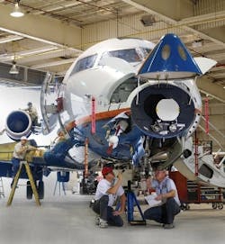 Mechanics work on a plane at AAR Aircraft Services Corp, in Oklahoma City, a few minutes away from Will Rogers World Airport. The company says it has at least 600 open jobs.