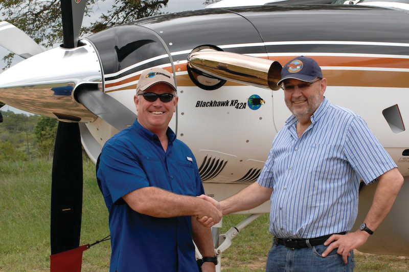 From left: Jim Allmon, president of Blackhawk, and Dr. Eugene Meyer celebrate delivery of Meyer's newly upgraded XP42A Cessna 208B Caravan. It is first delivery of a Blackhawk-upgraded Caravan in Africa.
