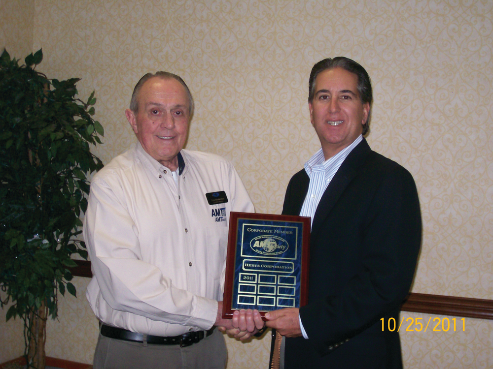 Scott Denequolo, senior director, sales strategy and operations, from Hertz accepting the plaque from Tom Hendershot for the benefits that Hertz provides AMTSociety members.