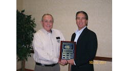 Scott Denequolo, senior director, sales strategy and operations, from Hertz accepting the plaque from Tom Hendershot for the benefits that Hertz provides AMTSociety members.