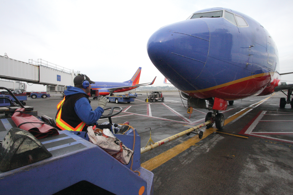 A Southwest Airlines tug operator uses Flightcom's wireless team communication system during a pushback at Portland International Airport