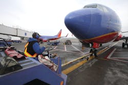 A Southwest Airlines tug operator uses Flightcom's wireless team communication system during a pushback at Portland International Airport A Southwest Airlines tug operator uses Flightcom's wireless team communication system during a pushback at Portland International Airport
