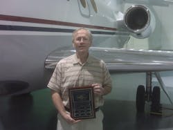 Gary S. Goodpaster accepted the plaque from AMTSociety; he is standing in front of the left wing of one of The Kroger Company's Falcon 50's. Gary S. Goodpaster accepted the plaque from AMTSociety; he is standing in front of the left wing of one of The Kroger Company's Falcon 50's.