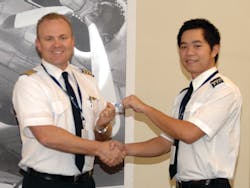 Pham Hai Bang (right) receives his pilot wings from Jerod Bybee, Chief Flight Instructor at CAE Global Academy Phoenix. Pham is one of the graduates of the first class of ab initio cadets trained by CAE for Vietnam Airlines. Pham Hai Bang (right) receives his pilot wings from Jerod Bybee, Chief Flight Instructor at CAE Global Academy Phoenix. Pham is one of the graduates of the first class of ab initio cadets trained by CAE for Vietnam Airlines.