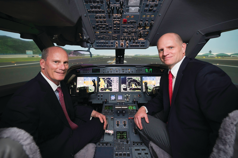 Larry Flynn, President of Gulfstream, and Eric Hinson, Executive Vice President of FlightSafety, in the new Gulfstream G450/G550 simulator located at the Hong Kong Learning Center.