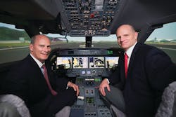 Larry Flynn, President of Gulfstream, and Eric Hinson, Executive Vice President of FlightSafety, in the new Gulfstream G450/G550 simulator located at the Hong Kong Learning Center.