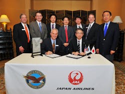 Jon Beatty, Pratt &amp; Whitney vice president, Airline Customers, (left) and Takahiro Abe, vice president, Purchasing, Japan Airlines Co., sign a Fleet Management Program agreement and a part repair agreement Wednesday evening at the Singapore Air Show as Pratt &amp; Whitney and Japan Airlines representatives look on. Under the agreements, Pratt &amp; Whitney will provide maintenance for the airline&apos;s Pratt &amp; Whitney-powered aircraft engines and engine parts.