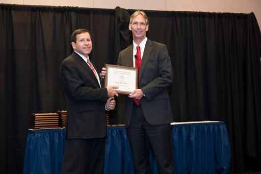 Connecticut Academy of Science & Engineering (CASE) vice president (left) congratulates Pratt & Whitney Senior Vice of Operations & Engineering Paul Adams on his induction into the academy.