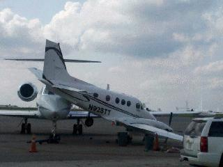 The Gulfstream was being towed when it apparently broke loose from the tug and collided into the parked Beechcraft. The nose of the Gulfstream wedged beneath the Beechcraft, lifting the rear of the smaller plane off the ground.