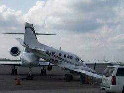 The Gulfstream was being towed when it apparently broke loose from the tug and collided into the parked Beechcraft. The nose of the Gulfstream wedged beneath the Beechcraft, lifting the rear of the smaller plane off the ground.
