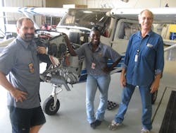 Embry-Riddle aircraft maintenance technicians (L-R) Ron Strauss, Juliet Oyula and Mike Fisher pose next to one of the Cessna 172s they fitted with the new quieter Gomolzig mufflers.