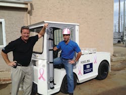 John Moore, senior vice president of sales and marketing, and Jamie Kaplan, president and CEO, Harlan Global Manufacturing, display an HLEPB pushback/cargo/bag tractor for US Airways Express painted with pink ribbons to mark Breast Cancer Awareness month during October. John Moore, senior vice president of sales and marketing, and Jamie Kaplan, president and CEO, Harlan Global Manufacturing, display an HLEPB pushback/cargo/bag tractor for US Airways Express painted with pink ribbons to mark Breast Cancer Awareness month during October.