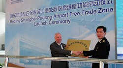 Lin Hai, Deputy Director of Shanghai Customs, presenting the Free Trade Zone plaque to Boeing Shanghai CEO Dermot Swan.