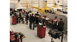 Robinson Helicopter maintenance students in the blade and hub learning area.