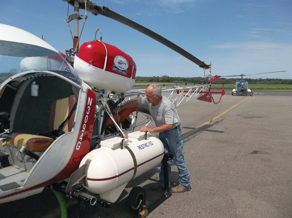 Scott Churchill readies a Model 47 prior to an aerial application flight.