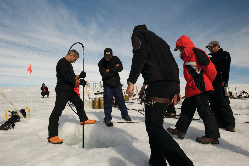 Robert 'WeeGee' Smith, left, of North South Polar, Inc. melts ice at the wreckage of the WWII Coast Guard J2F-4 Grumman Duck rescue aircraft missing for 70 years with three men aboard, beneath the ice near Koge Bay, Greenland, Aug. 29, 2012. An expedition team of Coast Guard servicemembers and North South Polar, Inc. Scientists and explorers located the crash site. U.S. Coast Guard photo by Petty Officer 2nd Class Jetta H. Disco.