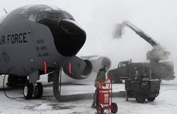 Members from the 92nd and 141st Aircraft Maintenance Squadrons apply de-icier and anti-ice chemicals to a KC-135 Stratontanker on the flightline at Fairchild Air Force Base, WA.