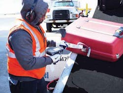 US Airways ramp agent scanning a bag going on, and coming off, airplanes in Philadelphia. US Airways ramp agent scanning a bag going on, and coming off, airplanes in Philadelphia.