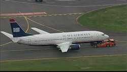 Maintenance crews put a new tire on the aircraft and towed it back to the gate. Maintenance crews put a new tire on the aircraft and towed it back to the gate.