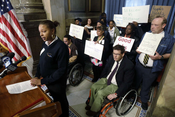 Wheelchair attendant Nikisha Watson outlines her group's complaints at a news conference.