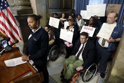 Wheelchair attendant Nikisha Watson outlines her group&apos;s complaints at a news conference.