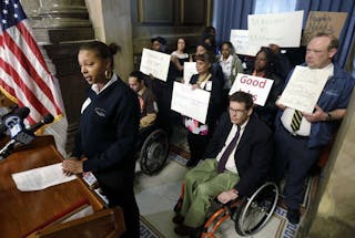 Wheelchair attendant Nikisha Watson outlines her group&apos;s complaints at a news conference.