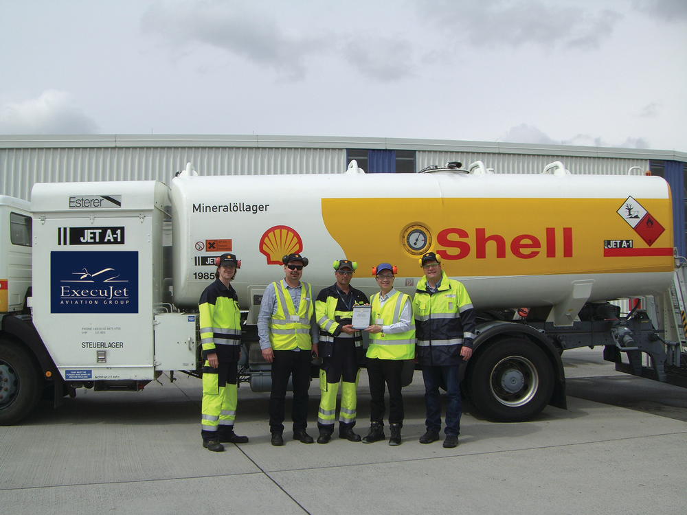 John Lo (second from right) , General Manager HSSE, Operations & Technical, Global Aviation, congratulates Bernd Dohnert (center), ramp agent at ExecuJet's Berlin FBO, for winning the Platinum Award.
