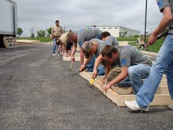 Palmer Johnson employees building an interior wall. Palmer Johnson employees building an interior wall.