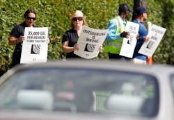 Union-represented employees waved signs -- such as 'Outsourcing is wrong' and 'United cares about its employees, until it can get 10 percent cheaper labor' -- at separate protests at 10 a.m. and 3 p.m. Union-represented employees waved signs -- such as 'Outsourcing is wrong' and 'United cares about its employees, until it can get 10 percent cheaper labor' -- at separate protests at 10 a.m. and 3 p.m.