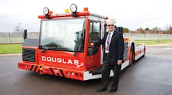 Michael Doane alongside a Douglas TBL 280 Towbarless Tractor on the day he officially &apos;retired.&apos; Doane a 50-year career with Douglas Equipment, 35 of those spent selling and marketing the company&apos;s GSE.