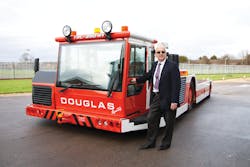 Michael Doane alongside a Douglas TBL 280 Towbarless Tractor on the day he officially &apos;retired.&apos; Doane a 50-year career with Douglas Equipment, 35 of those spent selling and marketing the company&apos;s GSE.