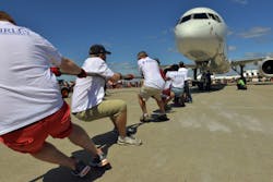 This year, 70 teams took part in the the Plane Pull charity event competing to pull a jet plane 12 feet in the shortest time. This year, 70 teams took part in the the Plane Pull charity event competing to pull a jet plane 12 feet in the shortest time.