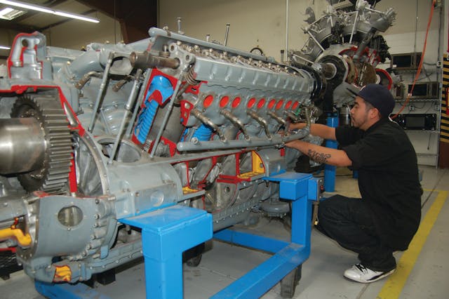 Juan Rodgriguez, a Redstone College student, works on a reciprocating engine, a core part of the A&amp;P training.