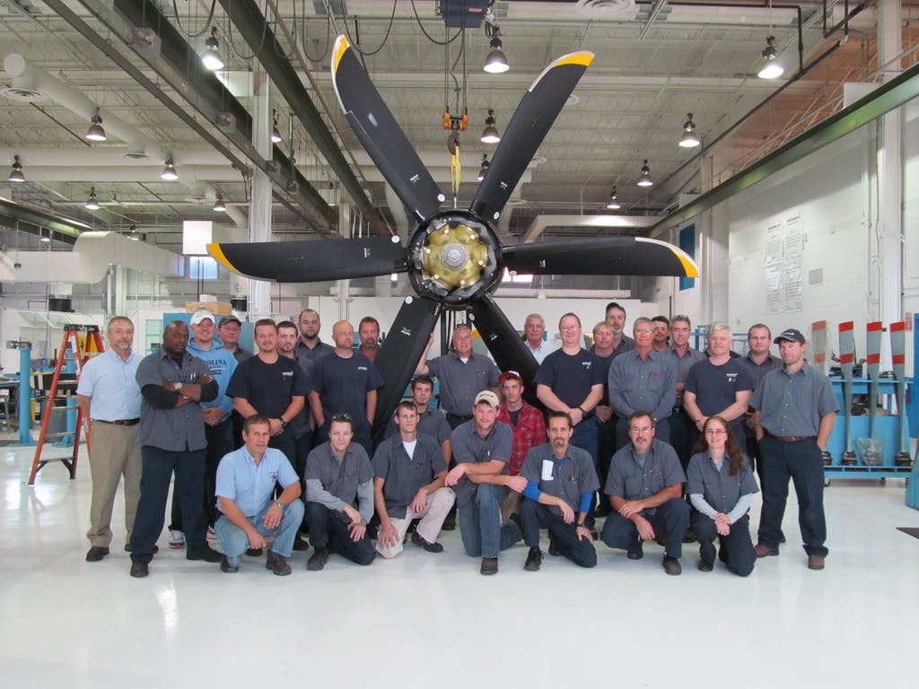 The PPS technical staff poses with a Dowty R408/Bombardier Q400 propeller.