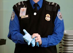 Tsa Agent Putting On Search Glove