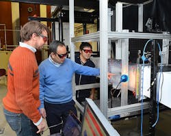 Rye Waldman, Hui Hu and Kai Zhang, left to right, work with the Iowa State University Icing Research Tunnel. Rye Waldman, Hui Hu and Kai Zhang, left to right, work with the Iowa State University Icing Research Tunnel.