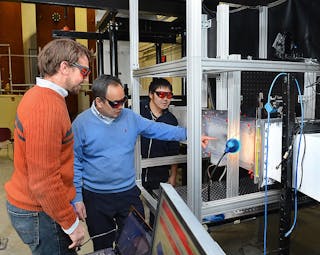 Rye Waldman, Hui Hu and Kai Zhang, left to right, work with the Iowa State University Icing Research Tunnel.