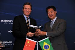 Bj&ouml;rn N&auml;f, CEO of Metrojet Limited and Guan Dongyuan, President of Embraer China in a ceremony held today at ABACE.