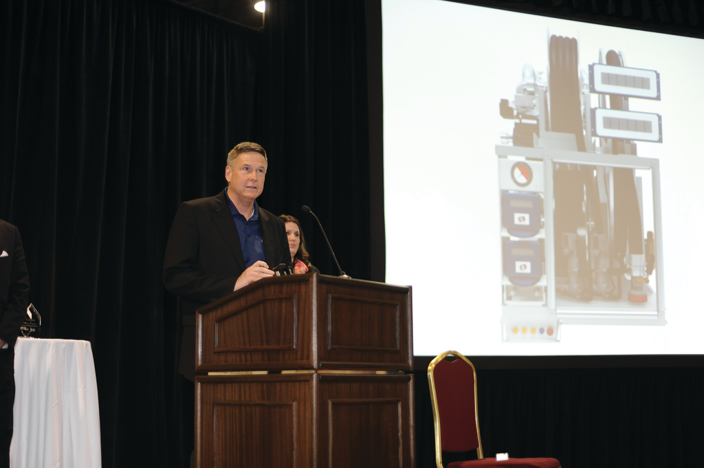 Kevin Ward, director of marketing and sales for Rampmaster, accepts the company's Ground Support Leader award at last month's AviationPros LIVE trade show in Las Vegas.