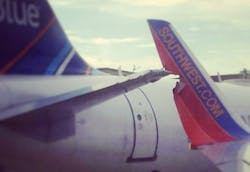 A Southwest Airlines jet backing away from a gate at Boston's Logan International Airport has struck a stationary JetBlue Airways plane, but no injuries have been reported. A Southwest Airlines jet backing away from a gate at Boston's Logan International Airport has struck a stationary JetBlue Airways plane, but no injuries have been reported.