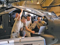 After soldiers master a task in virtual training, they use the portable computers to work on the real thing, here an AH-64 Apache helicopter.